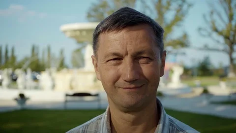 Smiling handsome man look at camera feel happy summer elderly outdoor footage Stock Footage 116997251