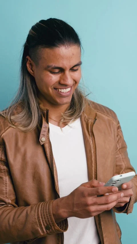 Smiling handsome man texting using mobile phone. Vertical Stock Footage 339325986