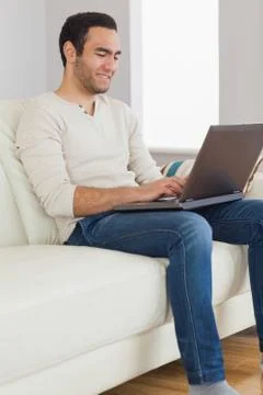 Smiling handsome man using his tablet computer Stock Photos