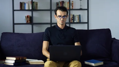 Smiling handsome student studying with laptop. New Technology, Education Concept Stock Footage 93282018