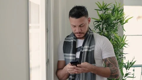 Smiling handsome young bearded man using smartphone. Stock Footage 101046764