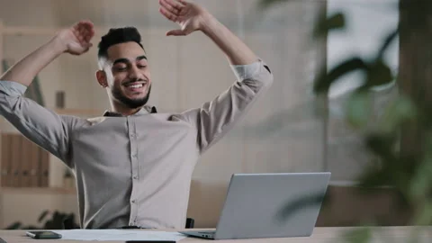Smiling happy arab man worker businessman finished task computer work relax sit Stock Footage 181878028