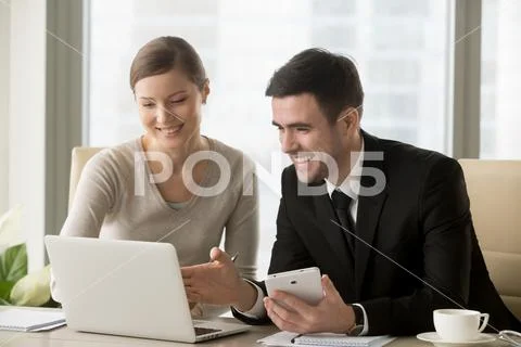 Smiling happy businesspeople using smart devices for mobile busi Stock Photos