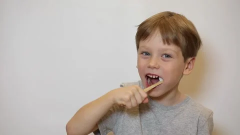 Smiling happy child brushing teeth with toothbrush. Dental hygiene of little boy Stock Footage 221326169
