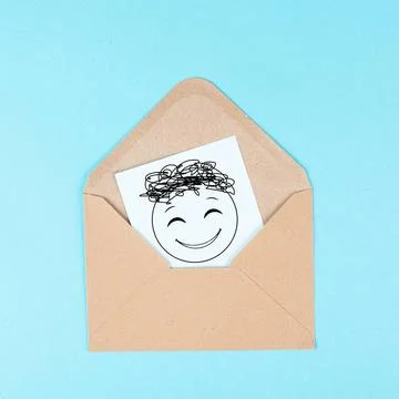 Smiling happy face on a paper inside an evelope, positive emotions, good c... Stock Photos