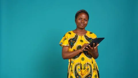 Smiling happy person checking internet websites on her tablet in studio Stock Photos