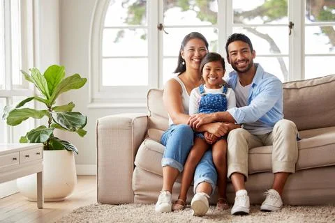 Smiling happy young ethnic family being affectionate and enjoying the weekend Stock Photos