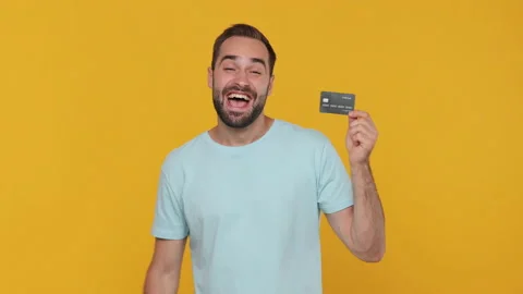 Smiling happy young man in basic casual blue t-shirt posing isolated on yellow Video stock 148291402
