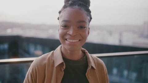 Smiling happy young pretty afro American woman looking at camera stand at Stock-Footage 151961920