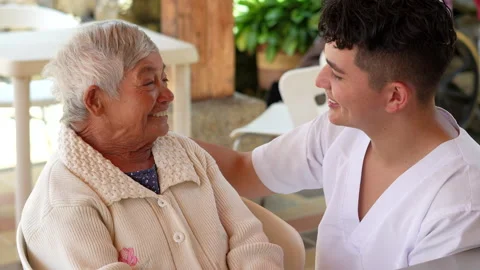 Smiling healthcare worker interacting with elderly woman. Stock Footage 284444138