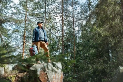 Smiling Hiker with Backpack Looking Up in Pine Forest Stock Photos