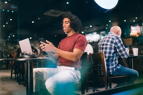 Smiling hipster guy with netbook browsing mobility information Stock Photos