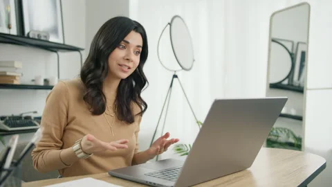 Smiling hispanic female student e-learning with online tutor at conference call Stock Footage 242882942