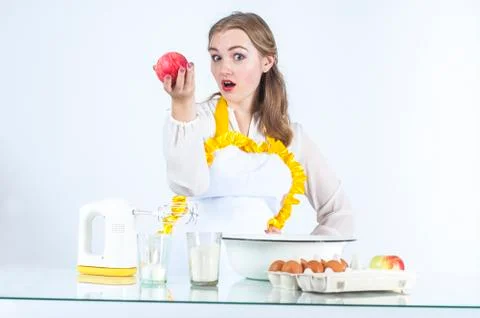 Smiling homemaker with apples Stock Photos