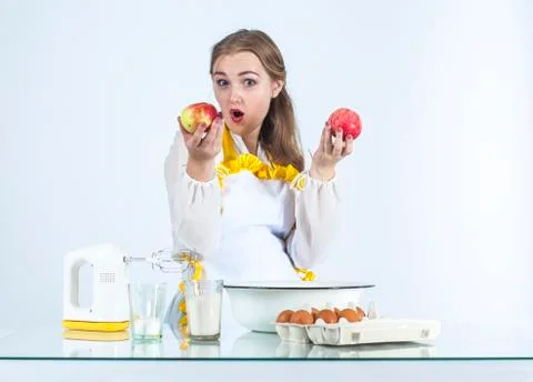 Smiling homemaker with apples Stock Photos