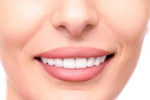 Smiling human face close-up, showing perfect teeth Stock Photos