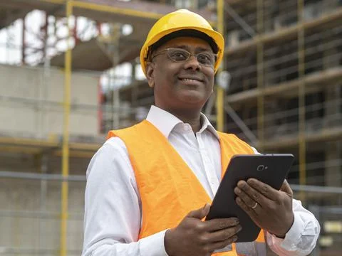 Smiling Indian engineer using tablet computer Stock Photos