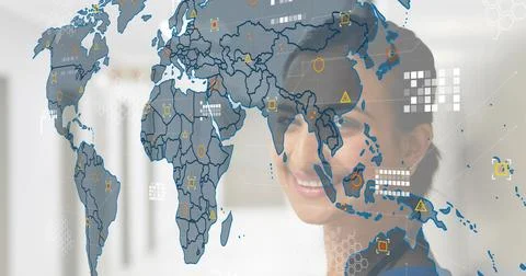 Smiling Indian exec in blazer viewing transparent world map at office with data Stock Photos