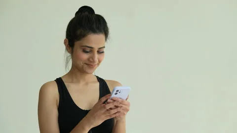 Smiling Indian female using cell phone checking. Stock-Footage 197019746