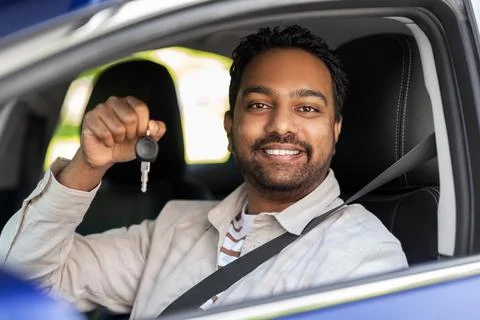 Smiling indian man or driver showing car key Stock Photos