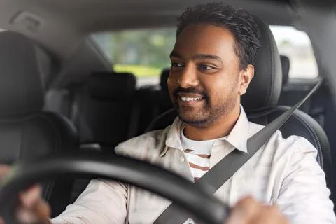 Smiling indian man or driver driving car Stock Photos