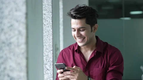 Smiling Indian Man using  smart phone And texting message enjoy social media. Stock Footage 170223329