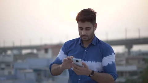 Smiling Indian mobile technology user enjoying internet,new app fun concept Stock-Footage 148382322