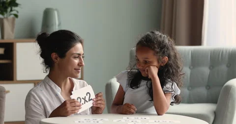 Smiling Indian mother study multiplication tables with little junior schoolgirl Stock Footage 191835354