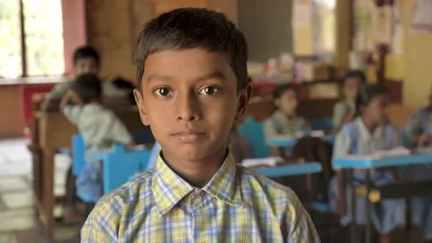 Smiling Indian Rural school boy in uniform looking at camera in active classroom Stock Footage 172043960