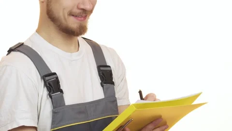 Smiling industry worker jotting down notes on a clipboard Stock Footage 311988641