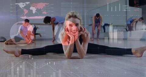 Smiling instructor in leggings performing side split in studio with wood floor, Stock Photos