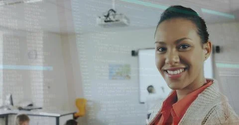 Smiling instructor presenting code in training room with projector and code o 写真素材