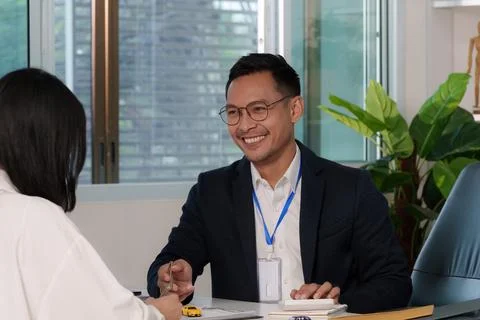 Smiling Insurance Agent Engaging with Client Stock Photos