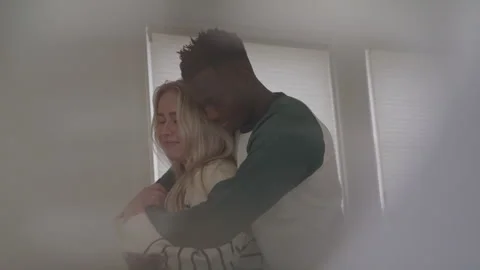 Smiling Interracial Couple Embracing Each Other in Their Bedroom Stock Footage 270297764