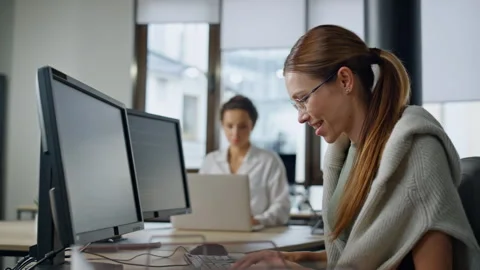 Smiling it woman programming software in... | Stock Video | Pond5