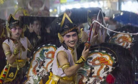 Smiling Javanese Kuda Lumping Dancer Performing Traditional Horse Dance in Rain Stock Photos