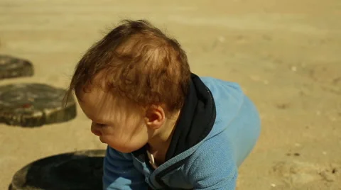 Smiling kid plays at the beach Video stock 63143335