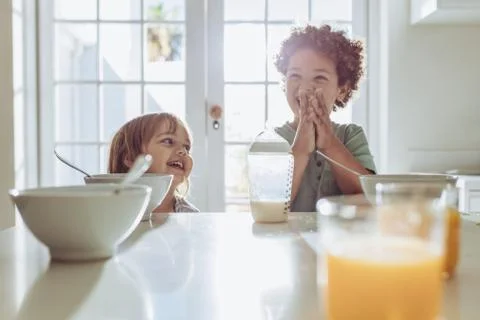 Smiling kids at the breakfast table Stock Photos