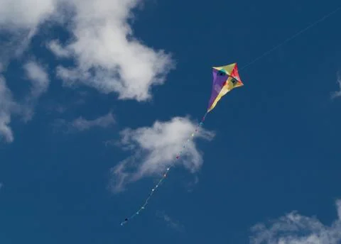 Smiling kite on the blue sky with clouds Stock Photos