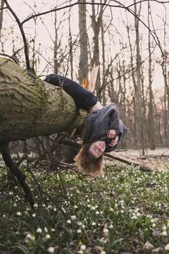 Smiling lady hanging on tree trunk scenic photography Stock Photos