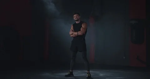 Smiling large athletic guy posing in front of the camera in a cross fitness Stock Footage 116900093