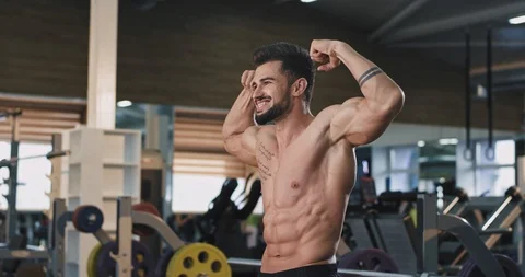 Smiling large attractive athletic guy bodybuilding concept at the gym man Stock Footage 114762376