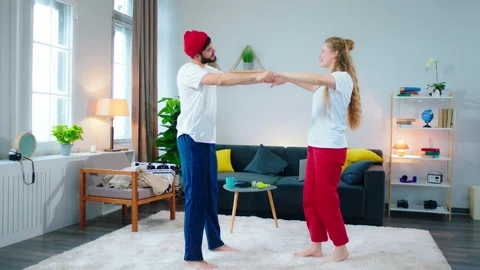 Smiling large charismatic couple feeling happy and relaxed at home dancing Stock Footage 156399123