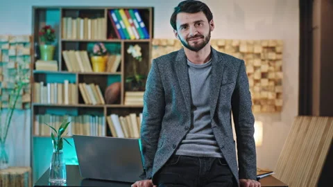 Smiling large in front of the camera charismatic office manger young man at the Video stock 136554710