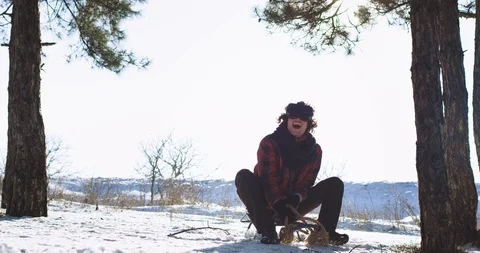 Smiling large good looking guy on a sleigh in the middle of winter forest using Video stock 111959825