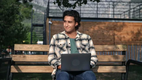 Smiling Latino programmer freelancer working use laptop remotely sitting on Vídeo Stock 219959435