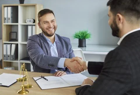 Smiling Lawyer Shaking Hands With Client In Office Stock Photos