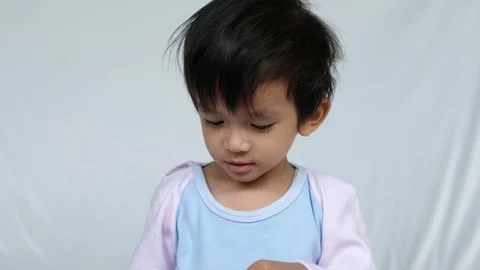 Smiling little boy plays with toy car | Stock Video | Pond5