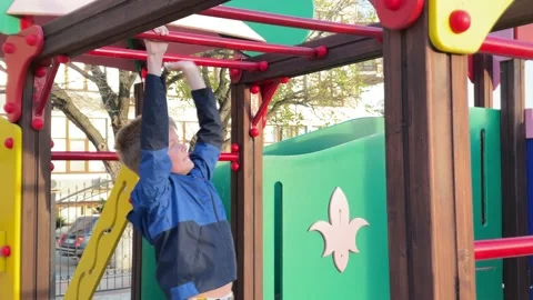 Smiling little boy training on playground Stock Footage 153512792