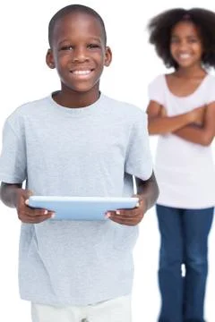 Smiling little boy using tablet pc Stock Photos